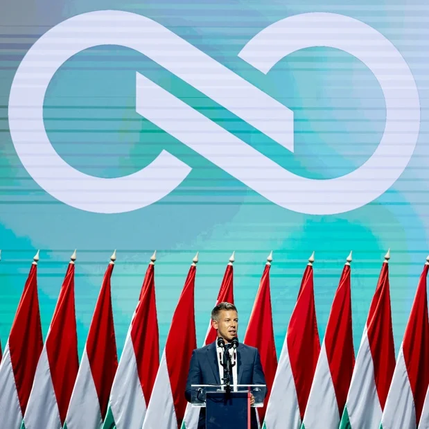 Tisza event with Hungarian flags and the party’s symbol behind the speaker